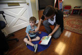 Melanie Feazell works with Declan Byrne during an ABA session.