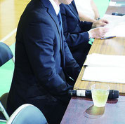 不適切な指導を謝罪し、保護者会の内容を報道陣に説明する校長や市教委関係者=24日夜、市内小学校