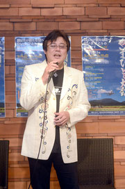 登野城出身のデザイナー大谷哲夫さんがデザインした紅型ジャケットを着こなし、「ばがけーら」を熱唱するミヤギさん=ホテル日航八重山