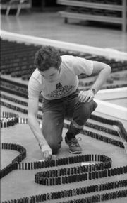 Michael Cairney removing a safety stop before toppling 169,713 dominoes in 1979, achieving a new world record. Photo Ⓒ Dennis E. Powell (http://www.flickr.com/photos/depscribe/collections/), used by permission.