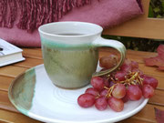 Tasse auf Teller, herbstlich arrangiert