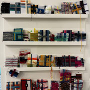Tartan weaving samples on cards left by museum visitors and docents
