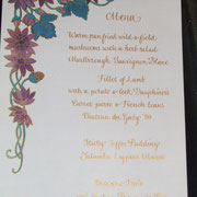 hand-decorated wedding menu in copperplate script in gold ink