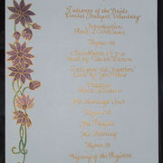 hand-decorated wedding order of service in gold copperplate script