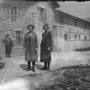 About 1925. A few workers in front of the main door of a factory of Rovereto (TN).