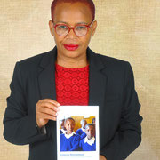 Rita Marque Mbata, President Women's Comfort Corner Zimbabwe with booklet "Entering Womanhodd"