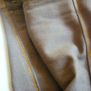 Handworked golden-yellow stitchings of Dutch Mountains Jeans