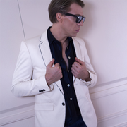 Ottaviano Blitch, Italian actor and performer, glamour editorial portrait in white suit and sunglasses against a light background, attore performer italiano ritratto moda glamour
