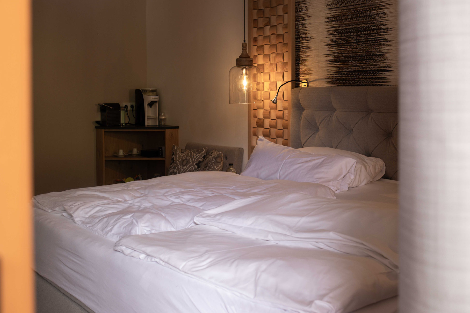 Stylish family room at OBERFORSTHOF with premium bedding, coffee station and modern alpine design.
