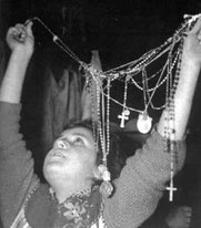 child holding religious object during blessing 