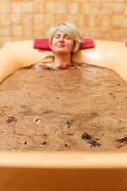 Mud bath tub with blonde woman at Jaunkemeri Sanatorium