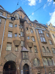 Brown Art Nouveau building influenced by Latvian folk architecture in Riga