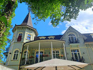 Timber building of Pegasa Pils Hotel on overcast day in Jurmala