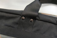 Reinforced handle attachment on a Japanese-made laptop bag for long-lasting durability