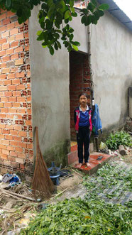 Thanh Hương, in front of the house