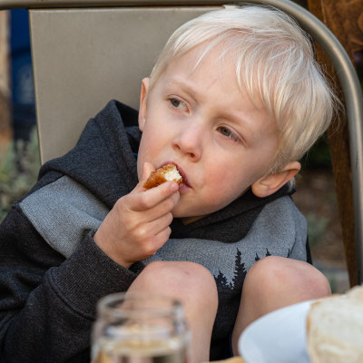 David's 90th birthday party guests - Owen trying out a chicken finger