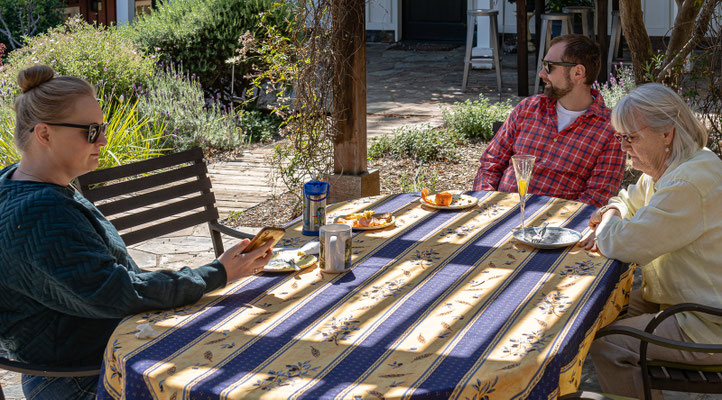 Zoe, Chris and Kathy enjoying the warm weather in Pat and Deon's Mediterranean-like garden