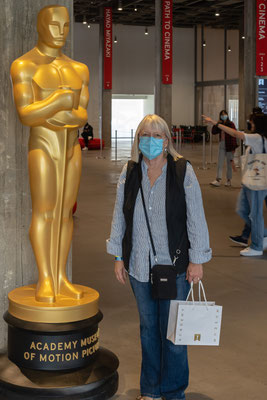 Kathy posing with Oscar at the Academy Museum of Motion Pictures