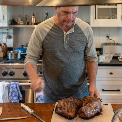 David's 90th birthday party guests - Pat's fixing the meat