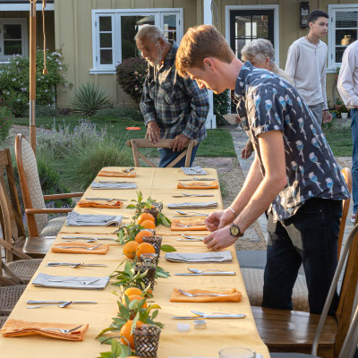 David's 90th birthday party - Matthew setting the table