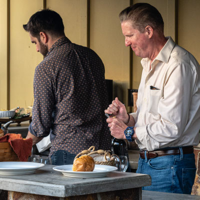 David's 90th birthday party guests - Zach and Greg bartending