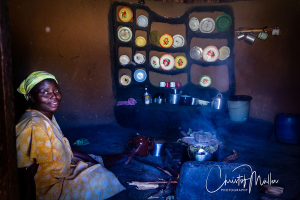A glimpse into the cultural heart of a home in Rural Zimbabwe, where cooking over open fire, the careful display of enamelware, and the presence of the woman herself reflect traditions of hospitality.
