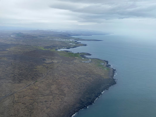 27.07. Aus dem Flugzeug blicken wir auf die isländische Küste. Um 16:00 landen wir in Keflavík.