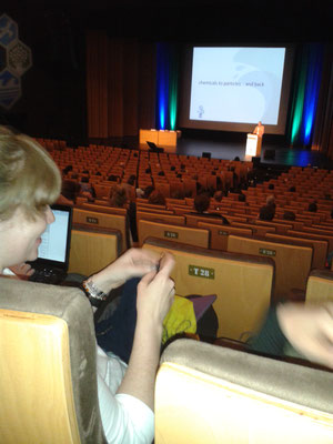 PhD student knitting during closing ceremony (multi-tasking!)