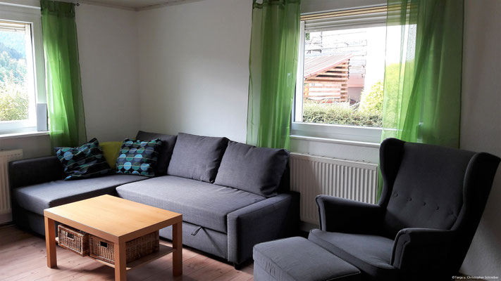 Couch und gemütlicher Sessel im Wohnzimmer