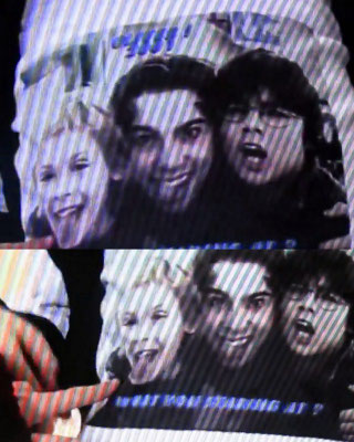 Joe's "Oliver!" shirt It says top:"Oliver! 2001" bottom: "What you staring at?" (Doger's first line to Oliver Twist)