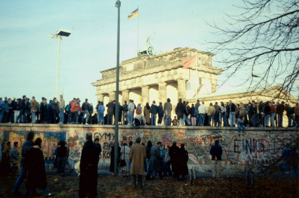 The day before the Berlin Wall fell: West-Berliners occupy the wall near Brandeburg Gate, 1989.