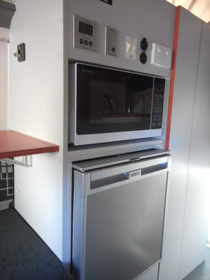 fridge and microwave in easy to reach height, micerowave and operation panels above