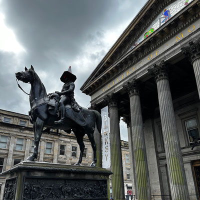 The people of Glasgow replace the traffic cone on the head of the first Duke of Wellington in front of the Glasgow Museum of Modern Art (GoMA)