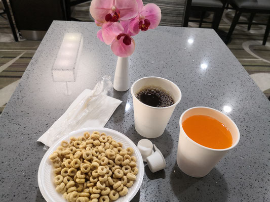 Das dunkle ist 'Kaffee', das grelle 'Orangensaft' - die Blume aus Plastik, ebenso das Besteck.