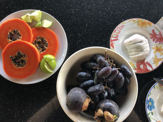 Local fruits for breakfast: papaya with lime, grapes, mangosteen, dragonfruit