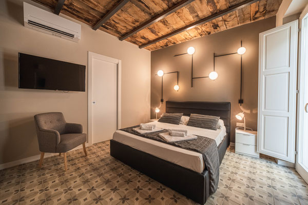 Blick vom Essbereich ins Schlafzimmer der Panarea Suite im Palazzo Paladini Luxury Suites