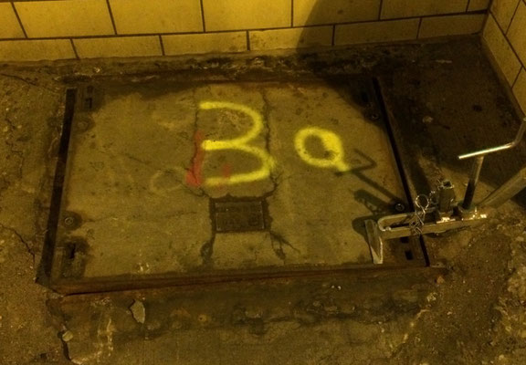 Alte verrostete Schachtabdeckung im Tunnel