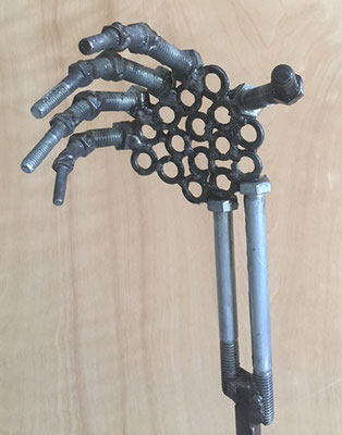 The hand is craftedx from nuts and bolts. 