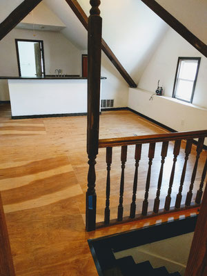 Standing in upstairs bedroom, looking at living room and kitchen at