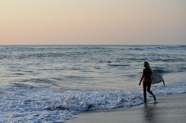 surfing by sunset