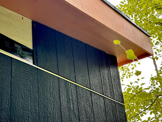 July 18, 2025. Painted LP Smart Siding is cut and applied in sections above the other 4' x 8' panels on the east side of the structure. Note the "Z" flashing installed between the two sections to prevent water infiltration.