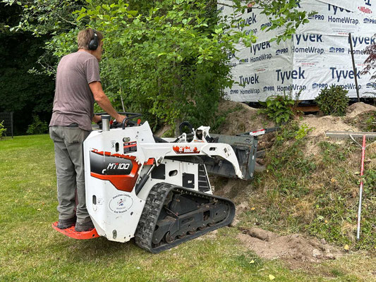 July 9, 2025. The trencher dug part way up the hillside, then Eric hand-dug the area up near the studio, where the trencher could not reach.
