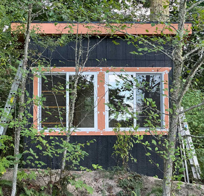 August 23, 2025. After painting with two coats of primer and two coats of paint, the front window trim was nailed into place and caulked, ready for touch-up painting.