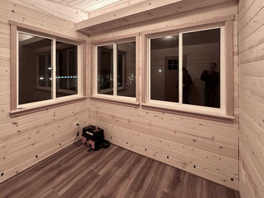 December 5, 2025. Completed window trim and floor installation.