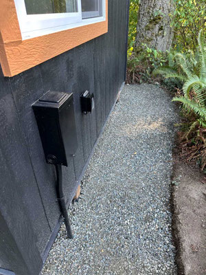 September 10, 2025. Gravel was added to the perimeter, helping prevent mud from splashing against the structure during rains. Also shown is the electrical box and outdoor outlet.