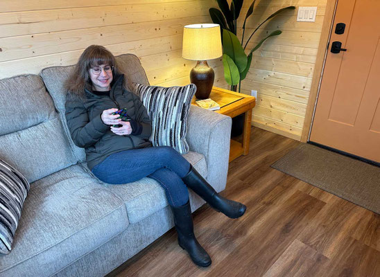 January 10, 2026. Lisa enjoying the loveseat, end table, lamp, and potted plant.
