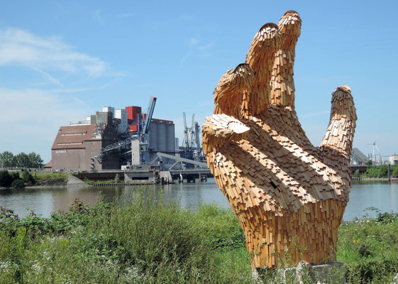 Überlebensgroße Holzhand des Künstlerkollektivs Kalihara, im Hintergrund der historische Rethe-Speicher. Foto: Christoph Schumann, 2020