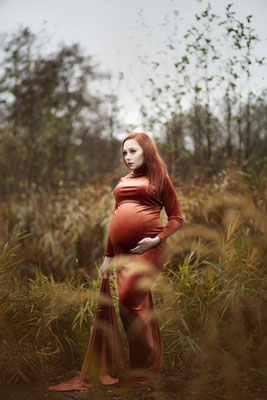 Soft editorial maternity portrait in a luxury studio