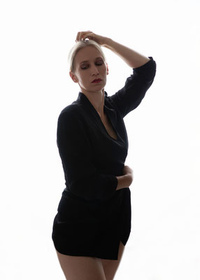 Luxury boudoir portrait of a confident woman in soft natural light