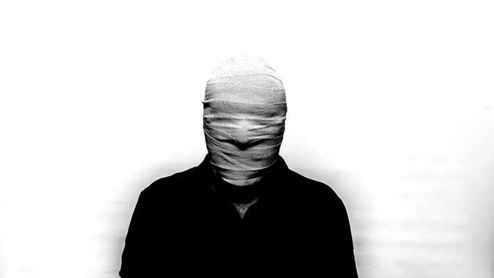 Mensch mit verbundenem Gesicht